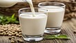 © Pricha.RT - A splash of soy milk being poured into a glass, creating a smooth, creamy swirl, perfect for a healthy breakfast.
