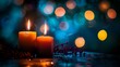 © Arifin Studio - Two burning candles on a table with red berries in the foreground and a blurred background of blue and orange bokeh lights.