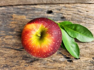 Ripe apple on wood background