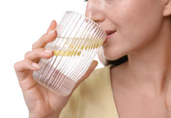 Poster - Woman drinking water with lemon on white background, closeup