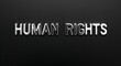 © Erlinda - human rights silver shining shiny solid metallic lettering on plain black background