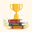 © solthanya - Gold trophy cup with stack of books, Winner prize goblet. Learn and succeed concept.