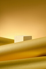 The image presents a white platform for product display, contrasting with the soft curves of golden paper, and soft, diffused lighting creating 