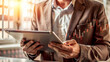 © HaJung - A Person Analyzing Financial Data on a Tablet Against a White Background for Digital Financial Analysis in Modern Business