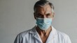 © Nemanja - Middle-aged doctor in white coat with surgical mask