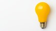 © Sariyono - Bright Yellow Light Bulb on White Background