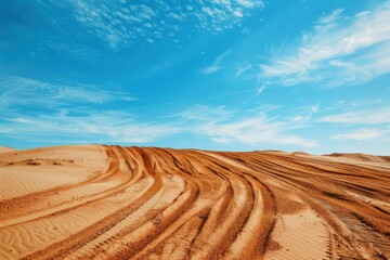 Motocross and auto track on blue sky background with sand wheel tracks