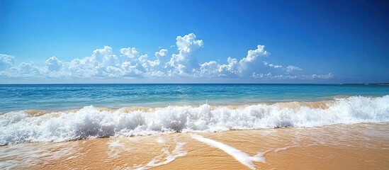 Peaceful Beach Scene with Foamy Waves and a Blue Sky