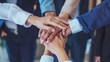© Tasnim - Business team putting hands together in a gesture of unity. Teamwork and collaboration concept.