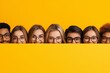 © Nataliia_Trushchenko - Group of people with glasses are standing behind a yellow board. There are at least 11 people in the group. diverse students peering down over wall, bottom half blank space, full yellow background