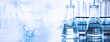 © bidala - flask and test tune in science research lab with blue banner background