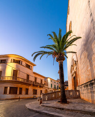 View of the famous gold stone architecture specific to the historic town Santanyi illuminated in evening lights, in Mallorca Balearic Island