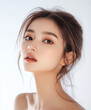 © Itsaya - young woman with natural makeup look poses gracefully, showcasing her radiant skin and elegant hairstyle. soft lighting enhances her features, creating serene and captivating atmosphere