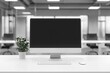 © ttonaorh - Minimalist white desk with a computer and office background, blurred business center interior in the blurred background. Mockup for design or presentation