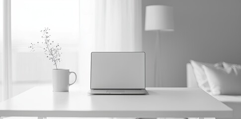 Wall Mural - Minimalist white office desk with laptop and coffee mug on a blurred background, with space for text, representing the concept of working from home