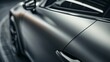 © Justlight - Closeup of a matte grey car paint finish with a subtle texture that gives the car a sophisticated and modern look.