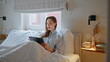 © stockbusters - Morning girl looking tablet relaxing in bedroom. Focused lady watching computer