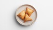 © Александра Ходорковс - Samosa on a plate, on white plain isolated, top view