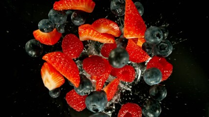 Aufkleber - Super Slow Motion of Falling Berries Mix into Water, Black Background. Filmed on High Speed Cinema Camera, 1000 fps. Camera Tracking the Target.