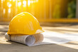 © mat - Yellow safety helmet placed on top of a rolled-up blueprint with copy space.