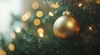 © aferalana - Close-up of a gold Christmas ornament on a tree, with a blurred lights background.