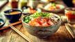 © edojob - Delicious poke bowl with salmon and rice being served on restaurant table