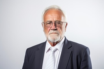 Portrait of a senior businessman in a suit and eyeglasses.