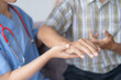 © Tj - Caring doctor checking patient's pulse, focusing on trust and wellness in healthcare setting