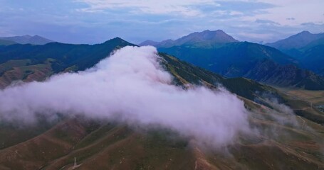 Sticker - Aerial view of white clouds and mountain natural landscape in summer. Beautiful mountain range scenery at dusk in Xinjiang, China. 