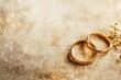 Two gold wedding rings on a vintage textured background with sepia tones and delicate floral accents. Generative AI