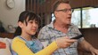 © InfiniteFlow - Grandfather and granddaughter together watch interesting entertainment media on TV. Old senior use technology communicate with young generation cross generation gap strengthen family bond. Divergence.