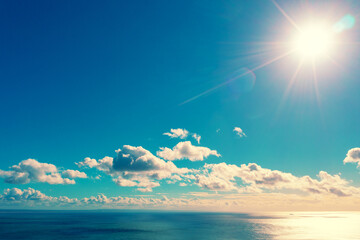 Wall Mural - beautiful day sky with the sun over the sea. seascape at daylight
