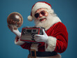 © Femmes.Digital - Santa Claus holding a retro boombox and a disco ball, grooving with holiday spirit. Vintage holiday portrait on blue background.