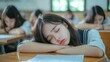 © PaulShlykov - Caucasian bored schoolgirl sleepy at school elementary education study learning tired exhausted sad upset fatigued. schoolchild lying at table desk lesson class relax health problem