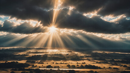 Wall Mural - A cloudy sky with the sun partially hidden behind the clouds, with sunbeams breaking through and illuminating the scene below in soft golden light
