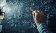 © jambulart - Person writing equations on chalkboard.