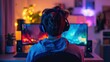 © hugy - Back view of a young man gaming on a PC desktop computer with multiple monitor display screens on the table