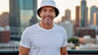 © QuoDesign - Man wearing white t-shirt and white bucket hat standing on cityscape background