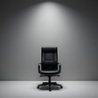 © IRINA - Stylish black office chair on a minimalist dark background
