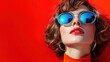 © svastix - A striking portrait of a woman with reflective turquoise sunglasses, showcasing bold red lipstick and vibrant backdrop, embodying empowerment and flair.