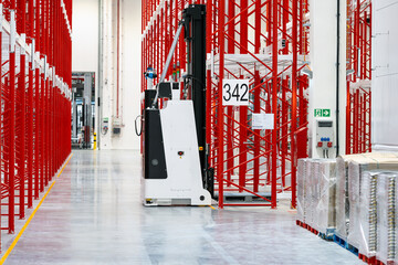 Red white racking system with forklift inside warehouse selective focus photography