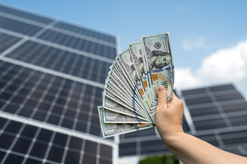 Poster -  man counts the profit of the US dollar from the sale of electricity, solar panels