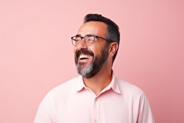 Wall Mural - Portrait of a happy mature man with eyeglasses against pink background