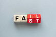 © Rochu_2008 - FAIL and FAST concept. letters on wooden blocks changing the word fast to fail, concept, beautiful gray background. flat lay, copy space