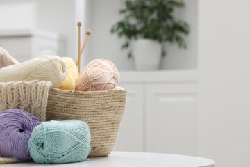 Canvas Print - Skeins of yarn, knitting sample and needles on white table indoors, space for text