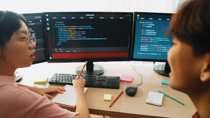 Slow motion back end software developer engineer for computer programming working together on debugging writing computing code, solving complex algorithms display on monitor in office. Burgeoning