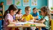 © jiwa - Four children are sitting at a table and drawing with crayons