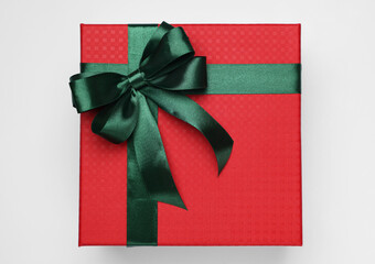 Canvas Print - Gift box with green bow on light grey background, top view