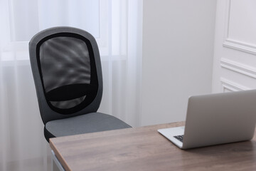 Poster - Black chair, laptop and desk in office