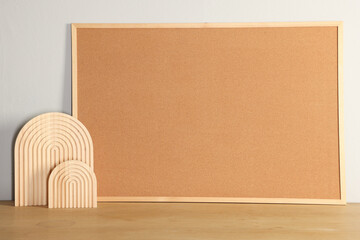 Canvas Print - Cork board and decorative elements on wooden table near light wall